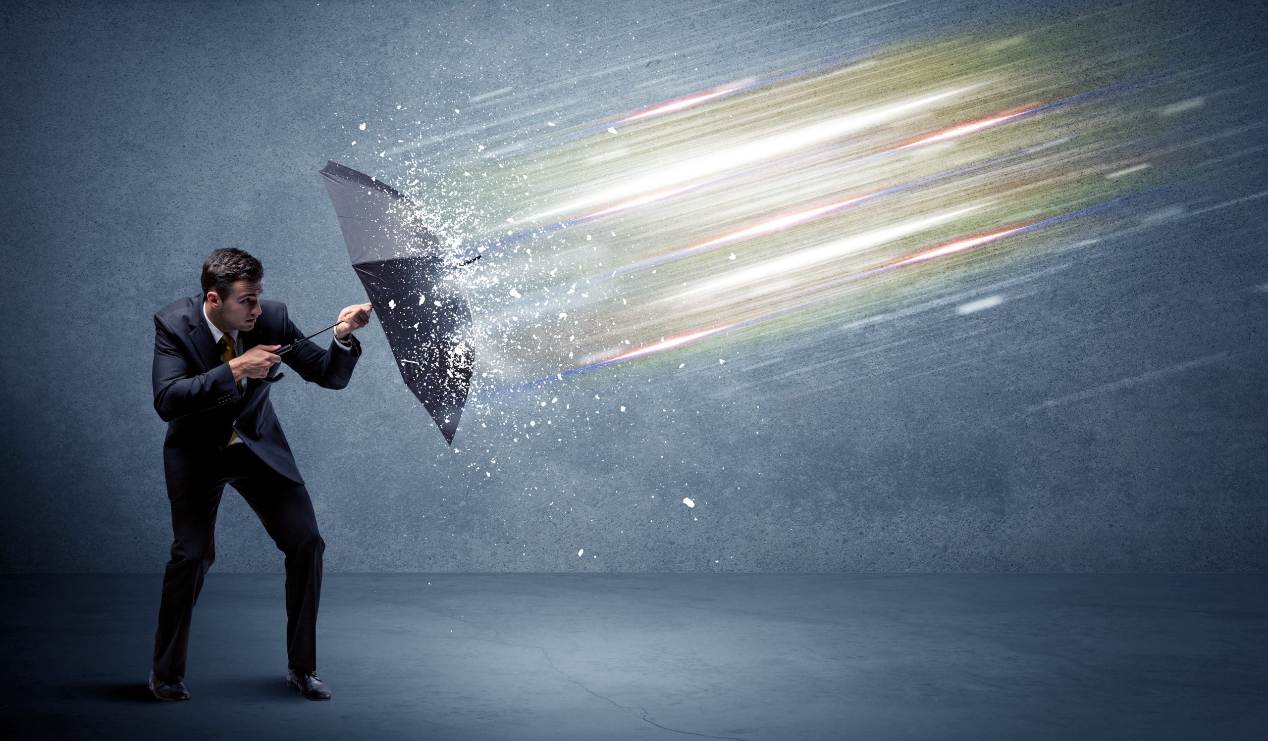 A man in a suit holding an umbrella to the side to shield off incoming light beams