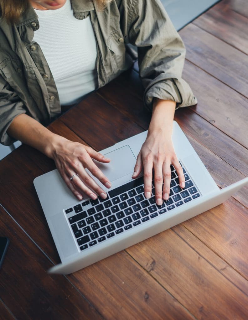 woman typing on a laptop
