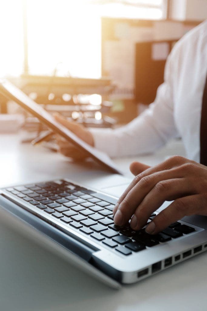closeup of a man typing on a keyboard