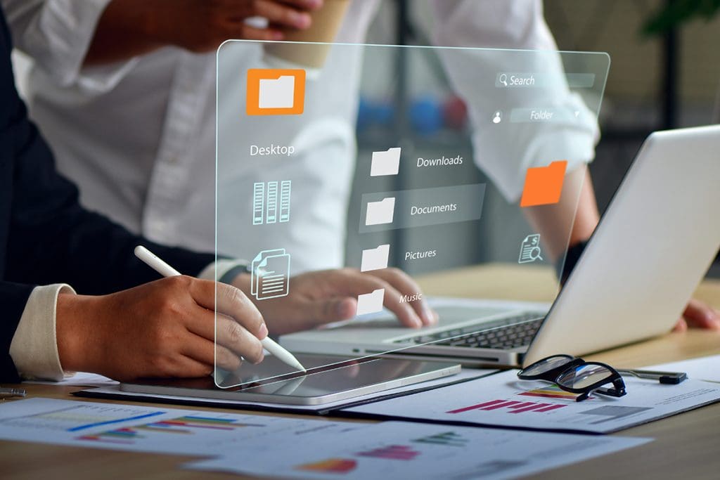 A person organizes files on their laptop.