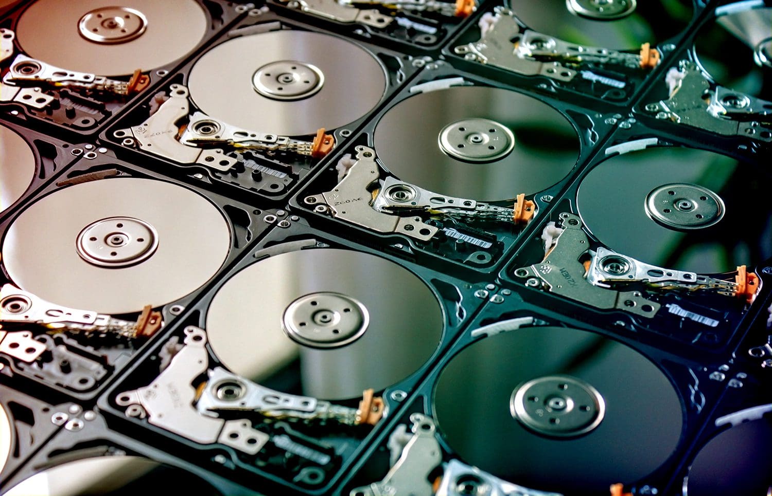 A large number of data hard drives laid out neatly.