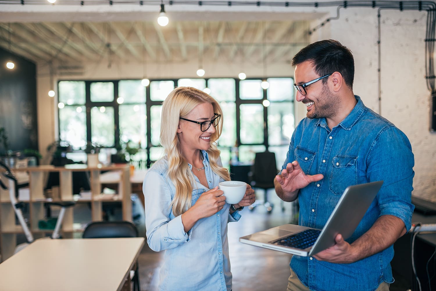 Business partners collaborating on a managed IT services plan in a modern office.