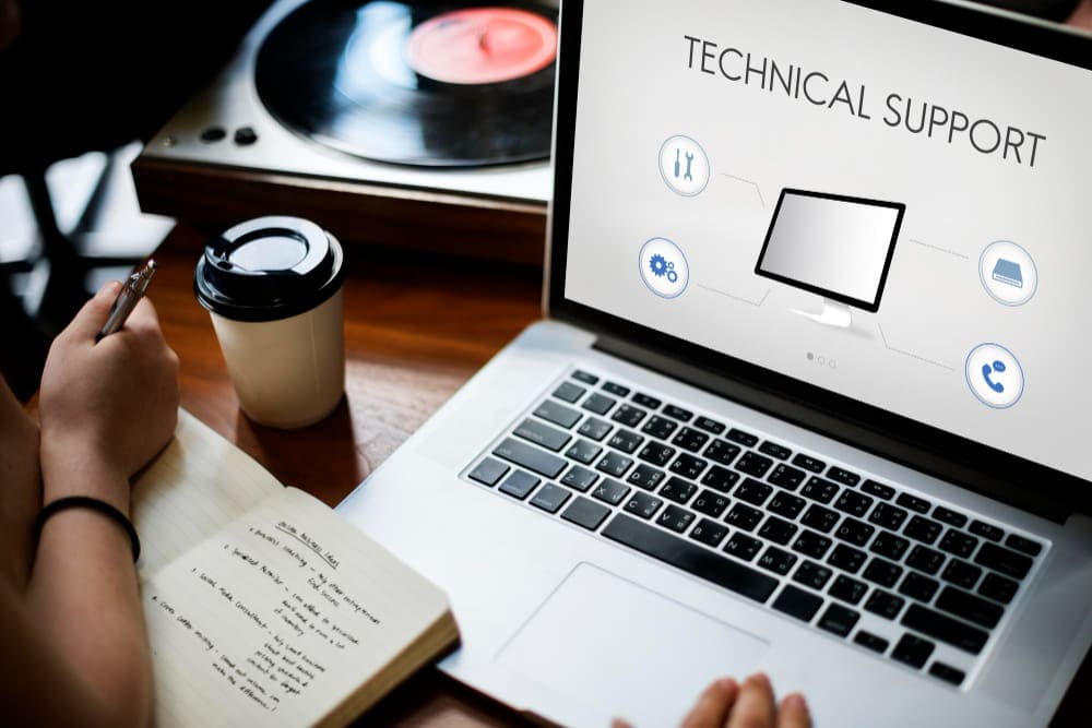 A person reviewing a technical support document on a laptop.