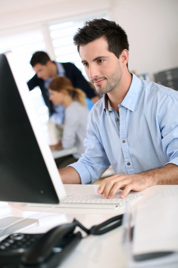 Man in office working on desktop computer