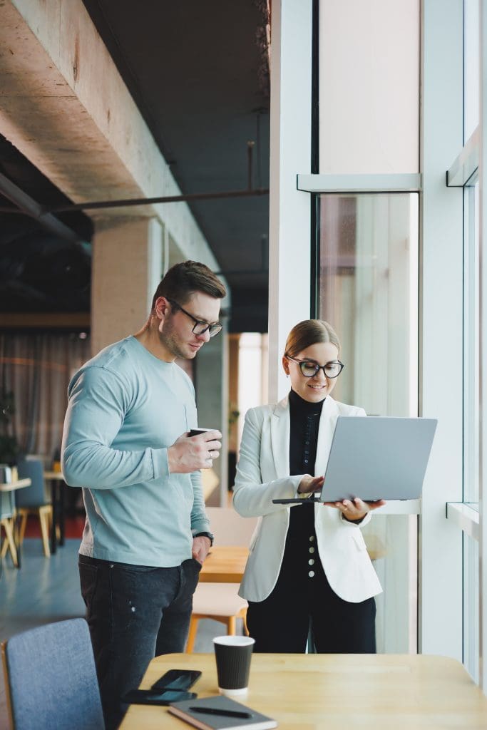 Business and woman looking at laptop